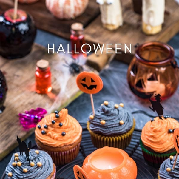 Cakes dressed with orange and black icing for Halloween party
